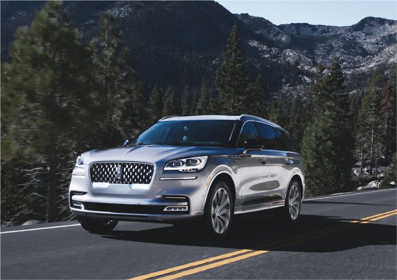 A 2023 Lincoln Aviator® Grand Touring SUV being driven on a winding road to demonstrate the capabilities of all-wheel drive | Zeigler Lincoln of Kalamazoo in Kalamazoo MI