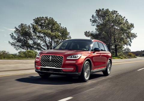A 2023 Lincoln Corsair® SUV is shown being driven on a country road. | Zeigler Lincoln of Kalamazoo in Kalamazoo MI
