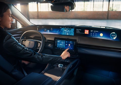 The driver of a 2024 Lincoln Nautilus® SUV interacts with the center touchscreen. | Zeigler Lincoln of Kalamazoo in Kalamazoo MI