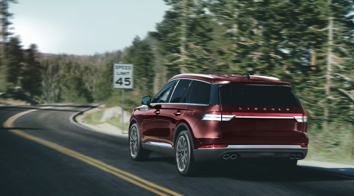 A 2024 Lincoln Aviator® SUV is being driven on a winding mountain road | Zeigler Lincoln of Kalamazoo in Kalamazoo MI