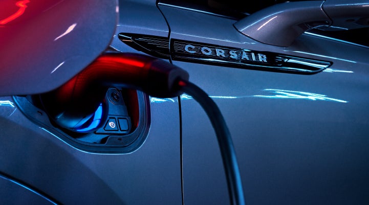 A charger plugged into the charging port of a 2024 Lincoln Corsair® Plug-in Hybrid model. | Zeigler Lincoln of Kalamazoo in Kalamazoo MI
