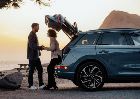 A couple share a moment together outside a 2025 Lincoln Corsair® SUV near the open liftgate. | Zeigler Lincoln of Kalamazoo in Kalamazoo MI