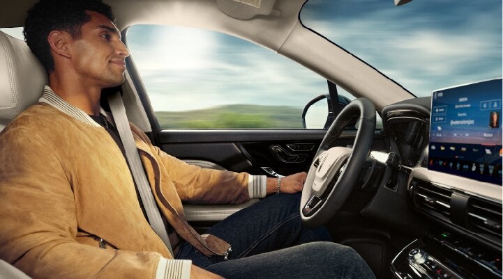 A person is shown using Lincoln BlueCruise hands-free highway driving technology on a divided highway called a Hands-Free Blue Zone. | Zeigler Lincoln of Kalamazoo in Kalamazoo MI