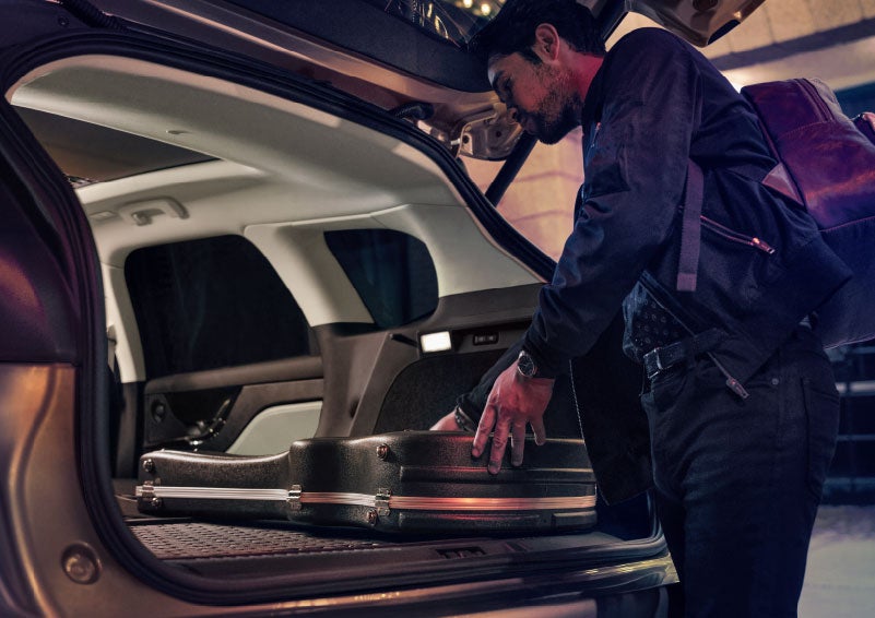 A man is shown loading cargo into the rear of a 2024 Lincoln Corsair® SUV with the second-row seats folded flat. | Zeigler Lincoln of Kalamazoo in Kalamazoo MI