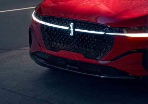 The available front LED light bar and center Lincoln Star logo glow at dusk. | Zeigler Lincoln of Kalamazoo in Kalamazoo MI