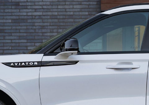 The driver’s side door and fender badging of a white 2026 Lincoln Aviator® SUV are showcased. | Zeigler Lincoln of Kalamazoo in Kalamazoo MI