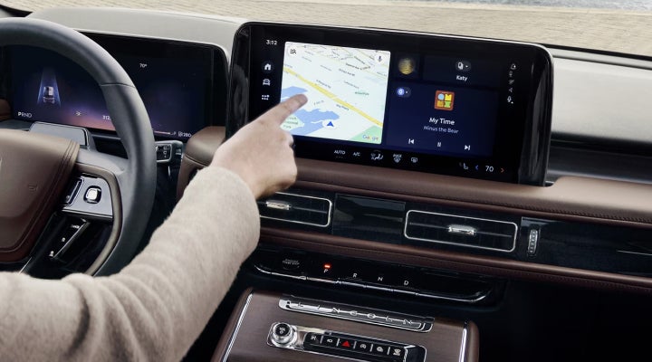 A person is tapping the center display touchscreen of a 2026 Lincoln Aviator® SUV. | Zeigler Lincoln of Kalamazoo in Kalamazoo MI