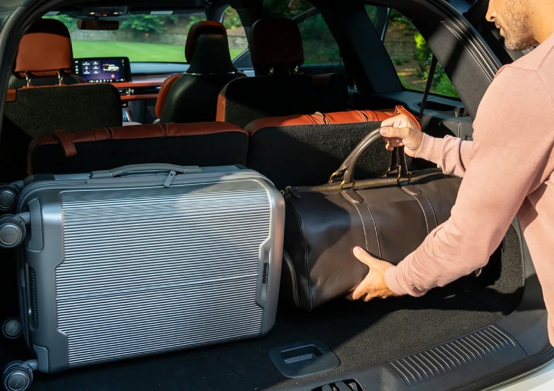 A man loads luggage into the rear of a 2026 Lincoln Aviator® SUV through the opened rear liftgate. | Zeigler Lincoln of Kalamazoo in Kalamazoo MI