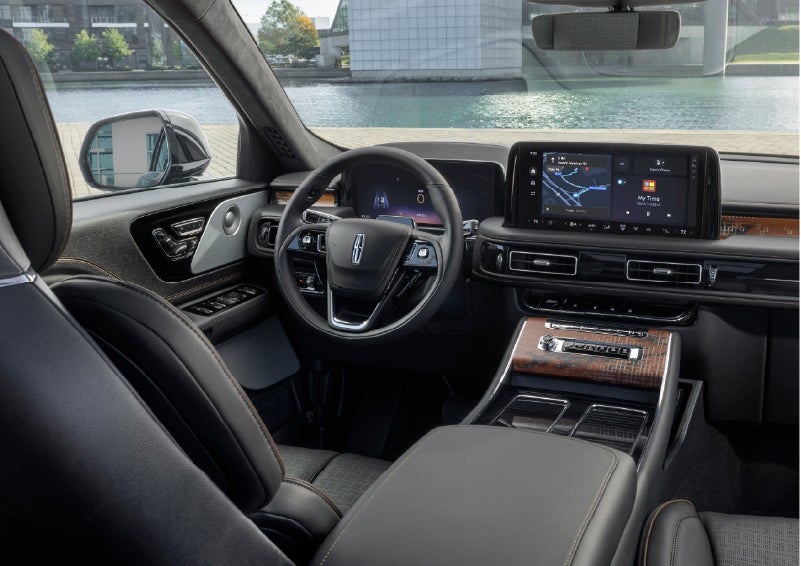 The interior of the 2026 Lincoln Aviator® SUV is shown parked with a view of a harbor through the windshield. | Zeigler Lincoln of Kalamazoo in Kalamazoo MI