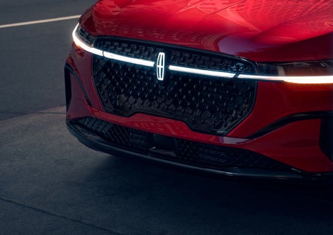 The available front LED light bar and center Lincoln Star logo glow at dusk. | Zeigler Lincoln of Kalamazoo in Kalamazoo MI