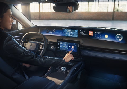 The driver of a 2026 Lincoln Nautilus® SUV interacts with the center touchscreen. | Zeigler Lincoln of Kalamazoo in Kalamazoo MI