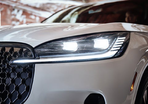 A close-up of a headlamp on the 2027 Lincoln Aviator® SUV is shown. | Zeigler Lincoln of Kalamazoo in Kalamazoo MI
