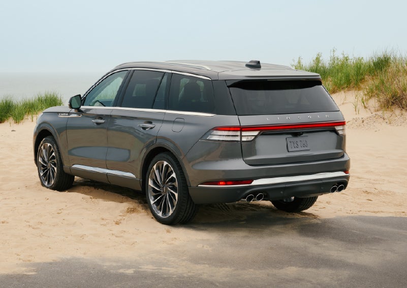 A 2027 Lincoln Aviator® SUV is parked next to sand dunes. | Zeigler Lincoln of Kalamazoo in Kalamazoo MI