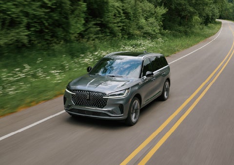 A 2027 Lincoln Aviator® SUV is being driven down a road. | Zeigler Lincoln of Kalamazoo in Kalamazoo MI