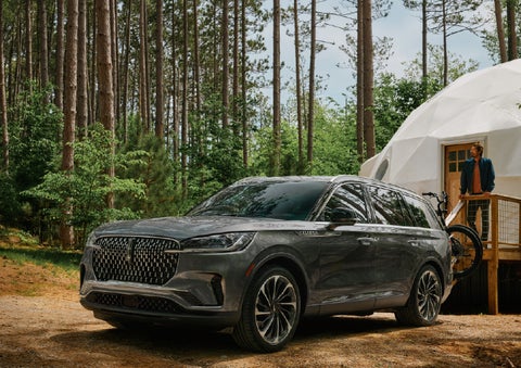 A 2027 Lincoln Aviator® is parked next to a high end glamping site. | Zeigler Lincoln of Kalamazoo in Kalamazoo MI
