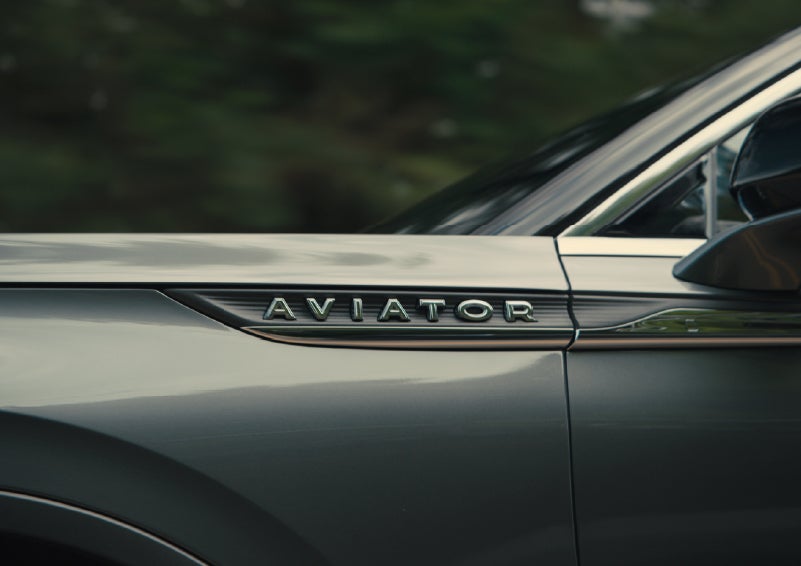 The driver’s side door and fender badging of a gray 2027 Lincoln Aviator® SUV are showcased. | Zeigler Lincoln of Kalamazoo in Kalamazoo MI