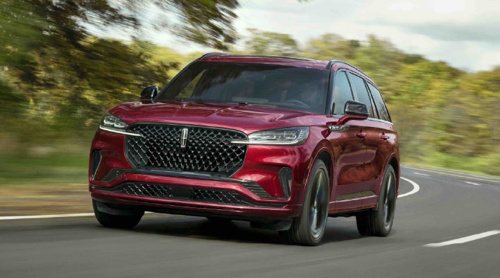 A 2027 Lincoln Aviator® SUV is being driven on a country road | Zeigler Lincoln of Kalamazoo in Kalamazoo MI