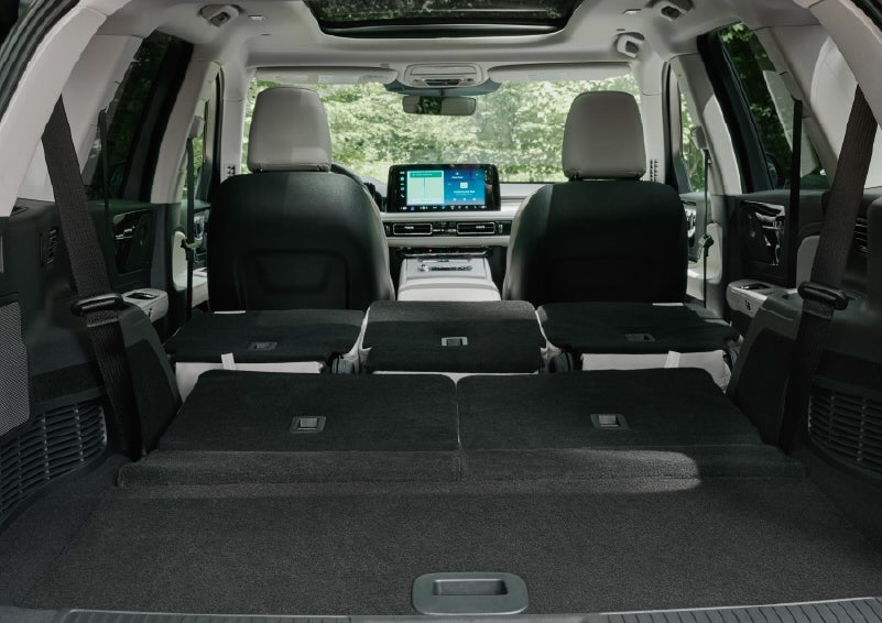 A rear to front view of the interior of a 2027 Lincoln Aviator® Black Label™ SUV shows the third and second rows folded flat | Zeigler Lincoln of Kalamazoo in Kalamazoo MI